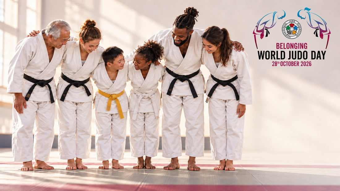 Four adults and two children in white judogi stand arm in arm in a dojo beside a World Judo Day 2026 Belonging graphic.